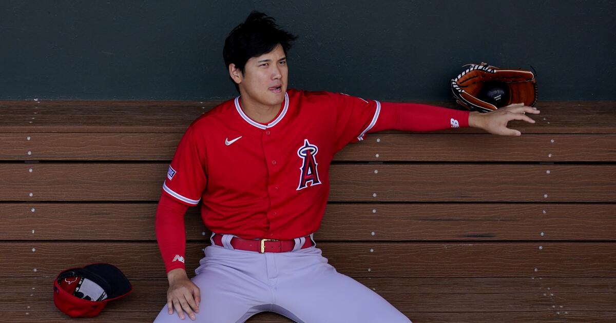 Shohei Ohtani of the Los Angeles Angels reacts after drawing a walk in the  fifth inning of a spring training baseball game against the Chicago Cubs on  March 24, 2022, in Tempe