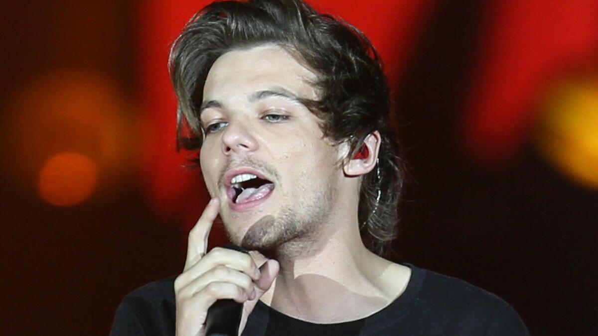 Louis Tomlinson, shown performing July 9 with One Direction in San Diego, is reportedly going to be a dad.