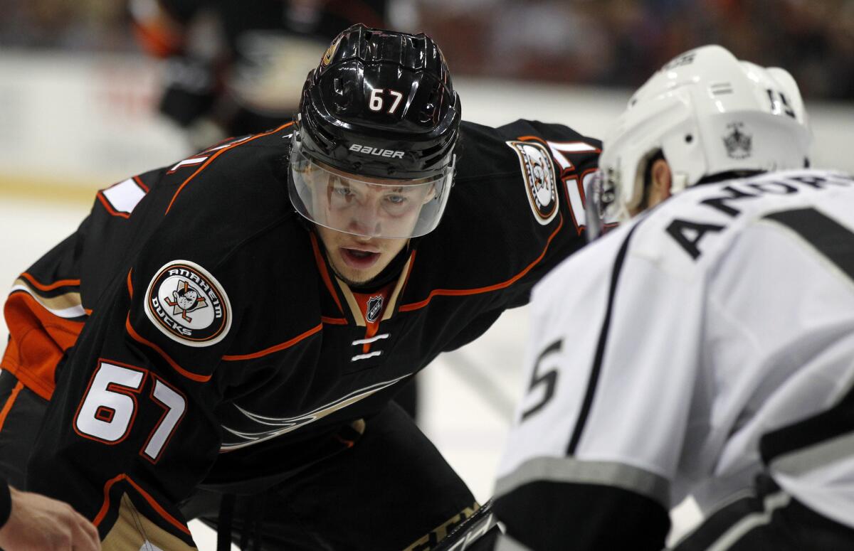 Ducks center Rickard Rakell faces off against Kings defenseman Jamie McBain during an NHL preseason game.