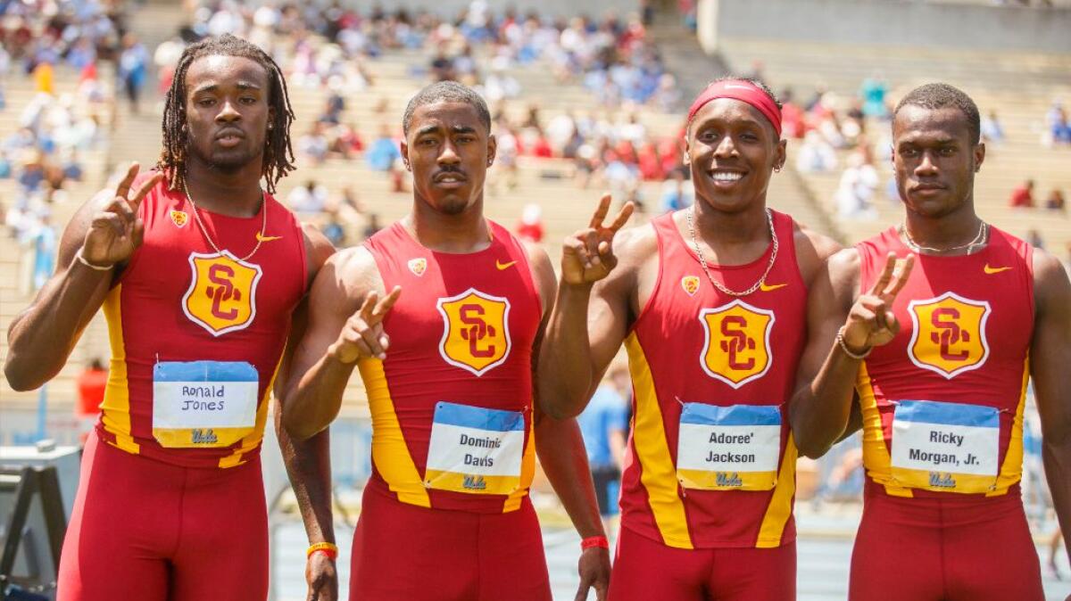 USC's Ronald Jones, Dominic Davis, Adoree' Jackson, and Ricky Morgan Jr., pose for a photo after winning the men's 400-meter relay during the UCLA vs. USC track and field dual meet on May 1.