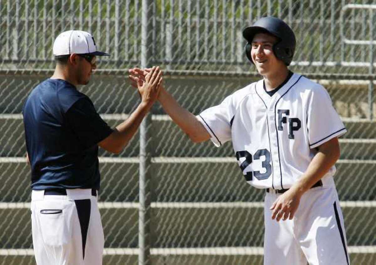 Flintridge Prep's Andrew Tsangeos is congratulated by his coach after hitting a run-scoring triple against Chadwick.
