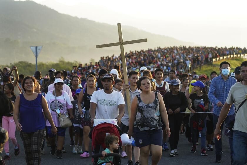 FILE - Migrants leave Huixtla, Chiapas state, Mexico, Oct. 27, 2021, as they continue their trek north toward Mexico's northern states and the U.S. border. The Biden administration struck agreement with Mexico to reinstate a Trump-era border policy next week that forces asylum-seekers to wait in Mexico for hearings in U.S. immigration court, U.S. officials said Thursday. (AP Photo/Marco Ugarte, file)