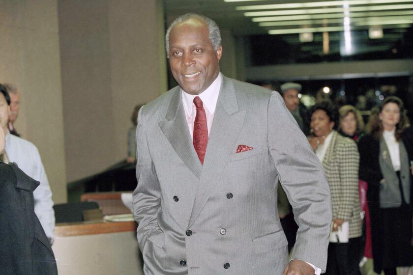 Vernon Jordan leaves his Washington law office after being named as chairman of President-elect Clinton's transition board, Nov. 6, 1992. Warren Christopher was named to manage the day-to-day details as transition director. (AP Photo/Wilfredo Lee)