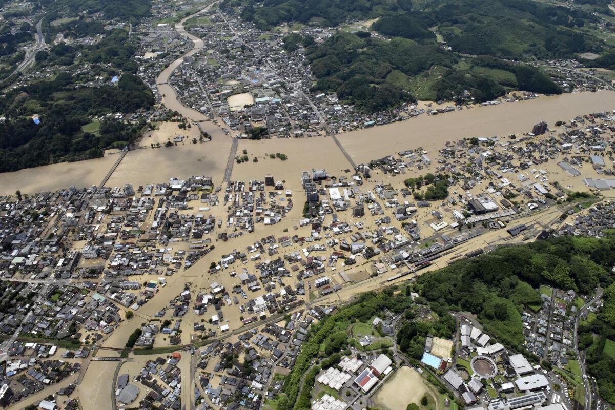 The flooded Kuma River and surrounding homes in Hitoyoshi, southwestern Japan