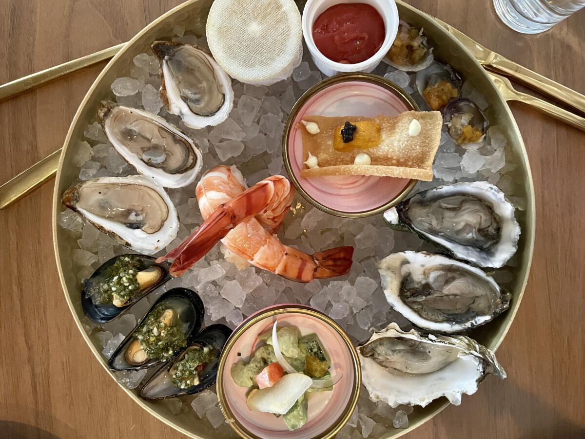 A seafood platter on ice at a restaurant.
