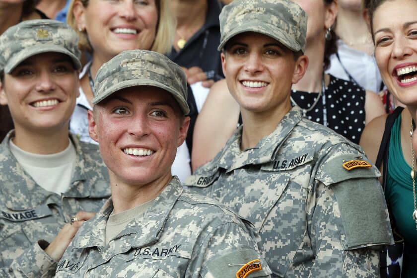 U.S. Army First Lt. Shaye Haver, center, and Capt. Kristen Griest, right, pose for photos with other female West Point alumni after an Army Ranger school graduation ceremony, Friday, Aug. 21, 2015, at Fort Benning, Ga. Haver and Griest became the first female graduates of the Army's rigorous Ranger School, putting a spotlight on the debate over women in combat. (AP Photo/John Bazemore)