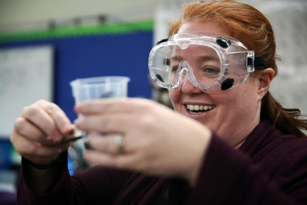 Jeanette Chipps smiles after seeing a student's successful work on a ferrofluid project at Granada Hills Charter High School. Chipps incorporates climate change into her curriculum and projects.