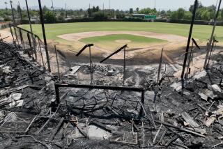 Ontario, CA - August 24: An aerial view of the remains of the historic wooden grandstand and dugouts after a late Thursday morning fire destroyed the historic baseball field and filming location at Jay Littleton Ball Park in Ontario Saturday, Aug. 24, 2024. A beloved community baseball stadium used for scenes in the 1992 film "A League of Their Own" and other Hollywood movies was damaged in a fire late Thursday in Ontario, California. Flames tore through the wooden grandstand and other parts of historic Jay Littleton Ball Park, a decades-old baseball gem that is currently home to Little League games and amateur leagues. Witnesses said they heard an explosion at about 11:30 p.m. Thursday.(Allen J. Schaben / Los Angeles Times)