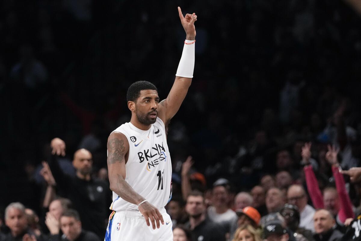 Brooklyn Nets guard Kyrie Irving reats after scoring a three-point basket during the second half of an NBA basketball game against the New York Knicks, Saturday, Jan. 28, 2023, in New York. The Nets won 122-115. (AP Photo/Mary Altaffer)