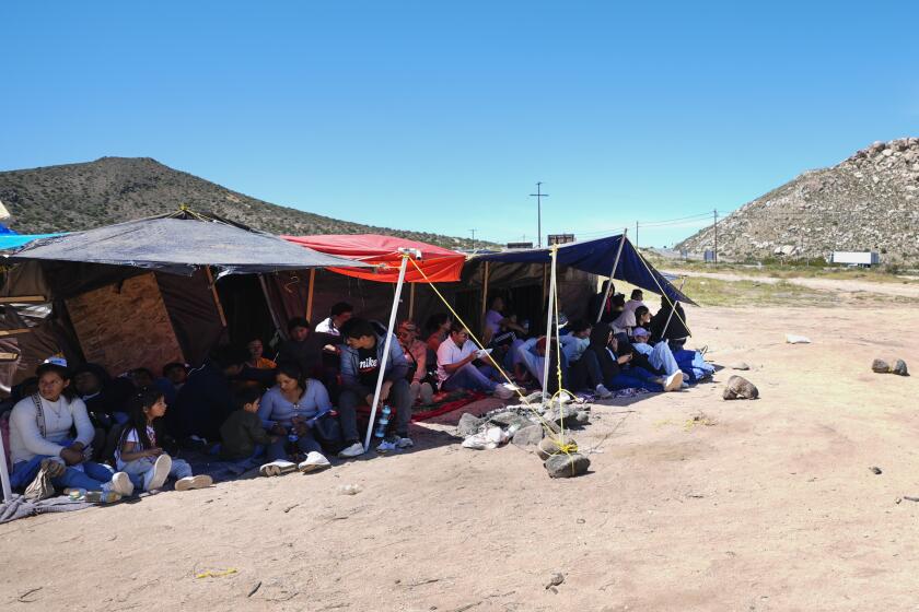 Un grupo de personas esperan a ser procesadas después de cruzar la frontera entre México y Estados Unidos para solicitar asilo, el miércoles 17 de abril de 2024, cerca de Jacumba, California. (AP Foto/Gregory Bull)