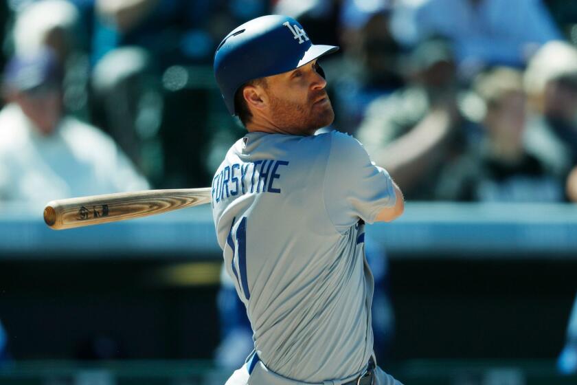 Los Angeles Dodgers' Logan Forsythe follows the flight of his RBI-singlein the fourth inning of a baseball game Sunday, April 9, 2017, in Denver. The Dodgers won 10-6. (AP Photo/David Zalubowski)