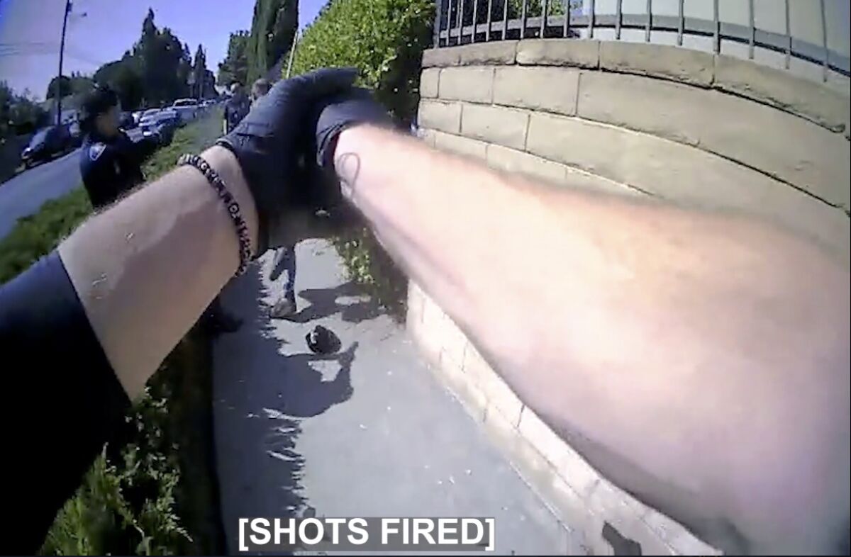 Police pointing weapons at a man in body camera footage with the subtitle "shots fired"