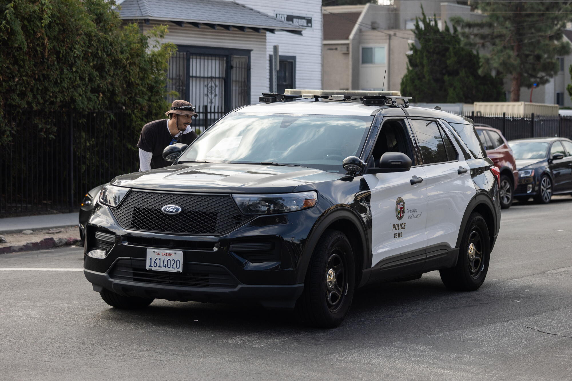 Jonathan Hale interacts pinch constabulary officers successful a patrol vehicle