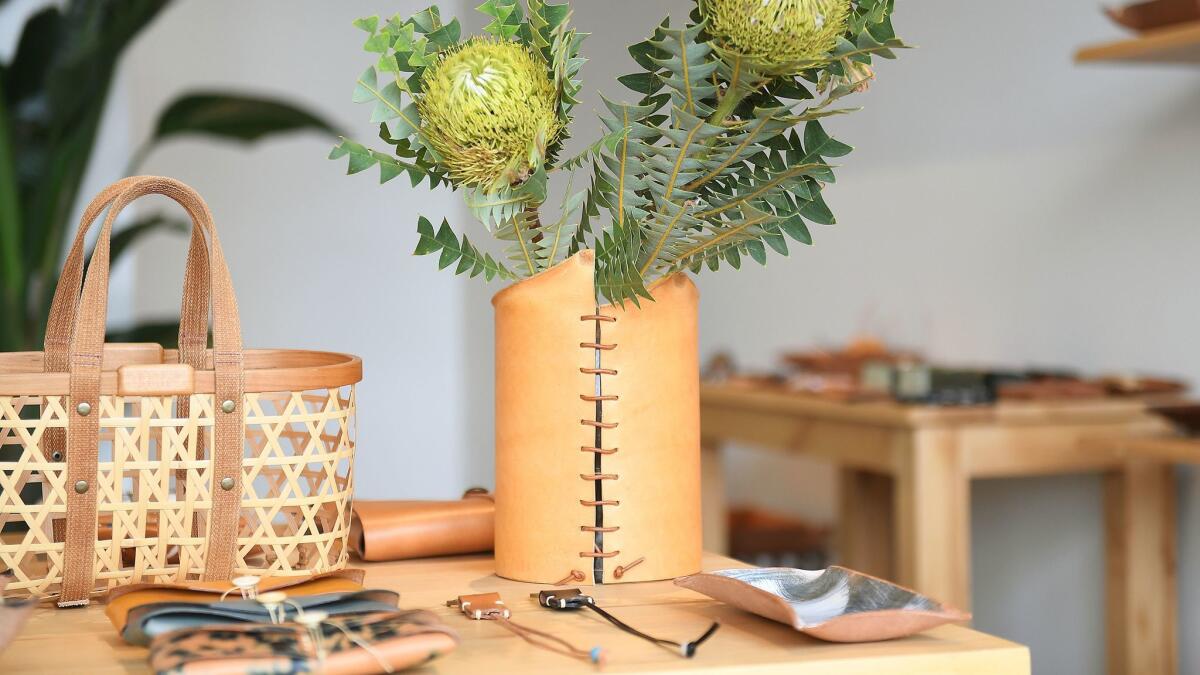 A leather-wrapped vase, center, and a woven bamboo tote are among the handcrafted leather goods and beaded accessories offered at Made Solid.