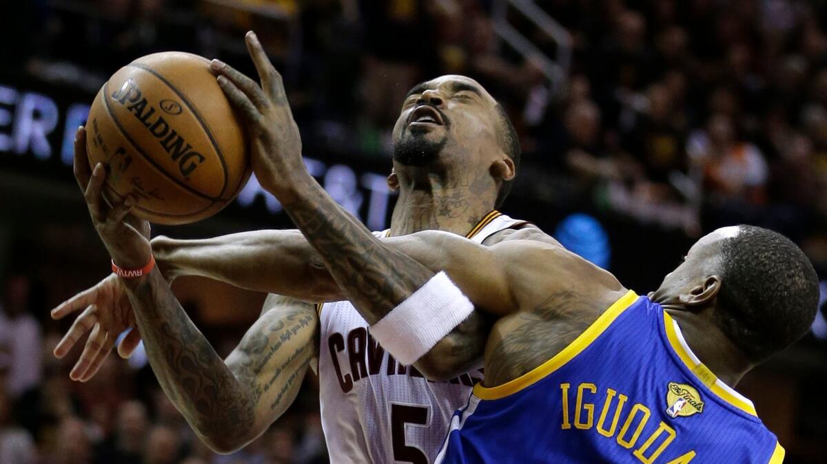 Cleveland guard J.R. Smith is fouled by Golden State forward Andre Iguodala on June 7.