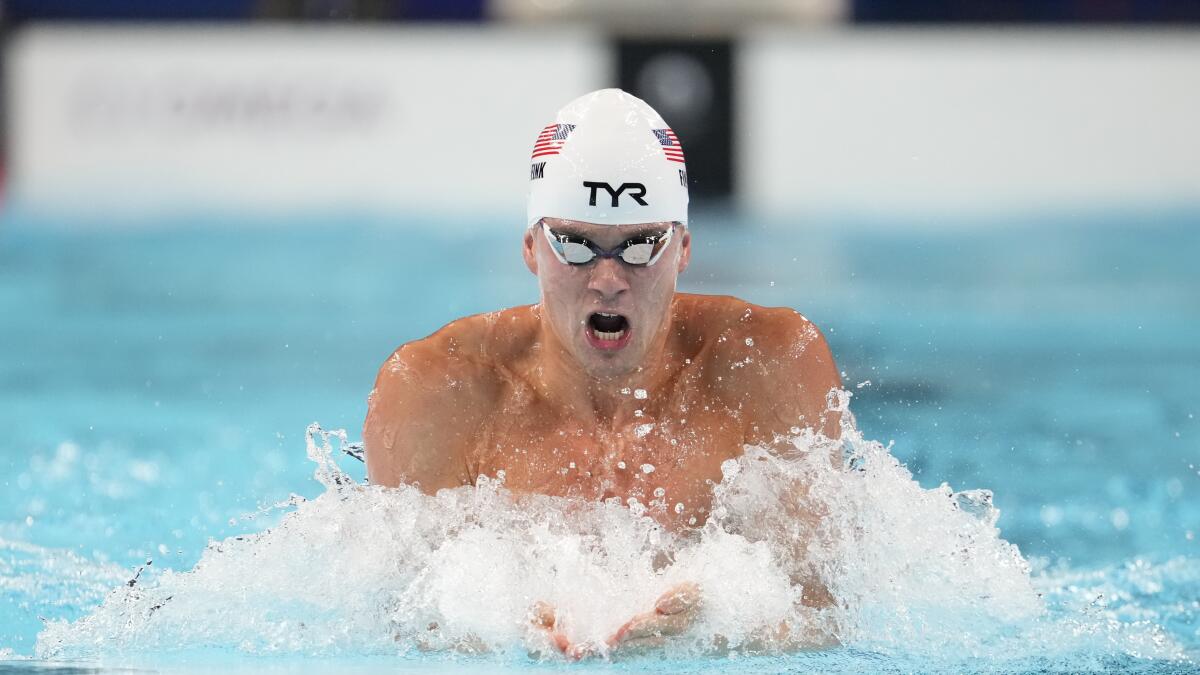 Nic Fink competes in the men's 100-meter breaststroke.