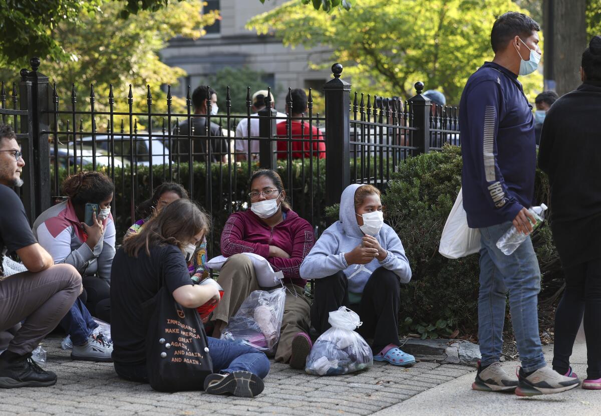 Migrants from Central and South America wait near the residence of Vice President Kamala Harris in Washington.