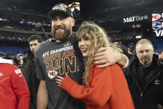 Kansas City Chiefs tight end Travis Kelce walks with Taylor Swift following the AFC Championship