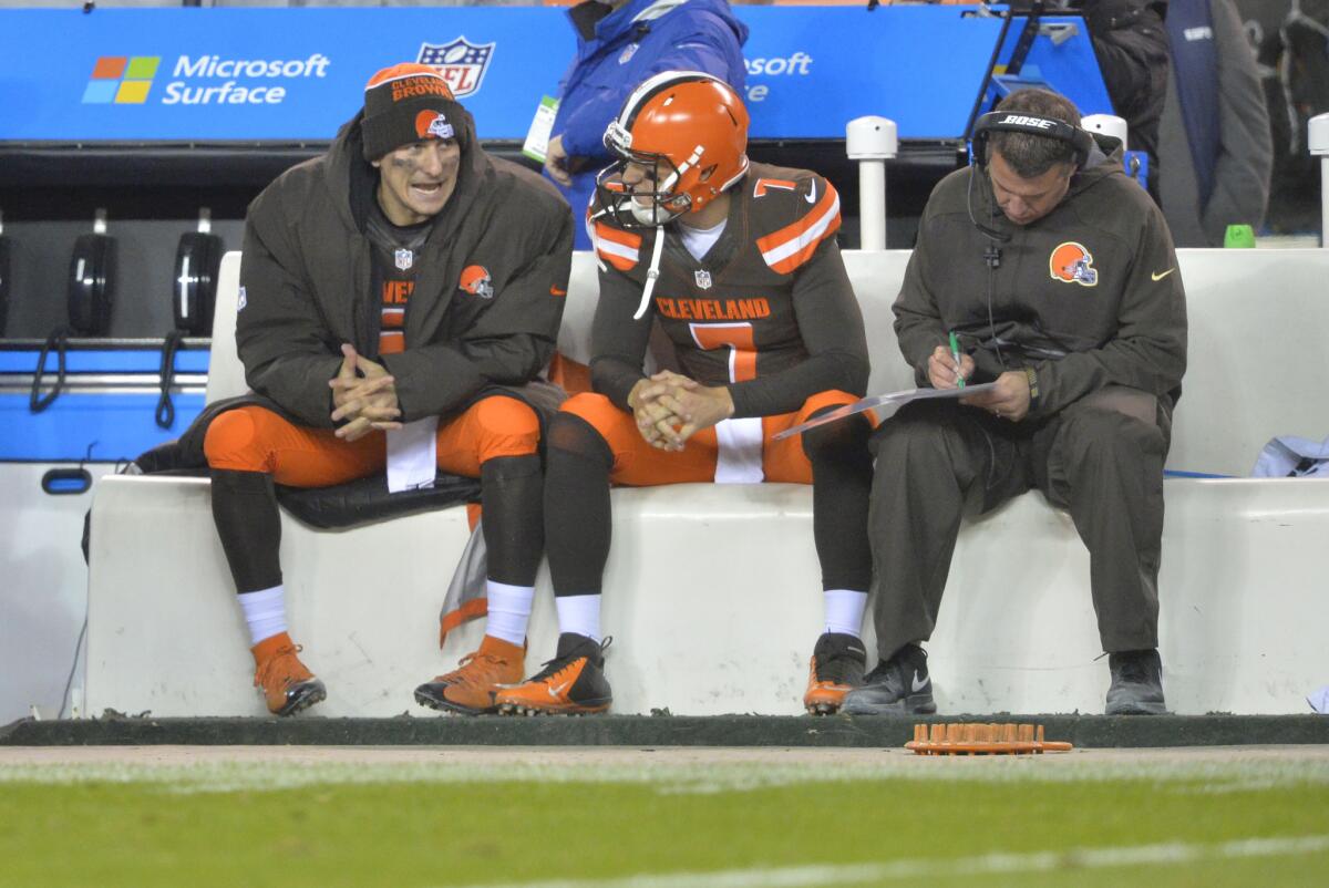 Cleveland quarterbacks Johnny Manziel, left, and Austin Davis talk during the Browns' game against Baltimore on Monday night.