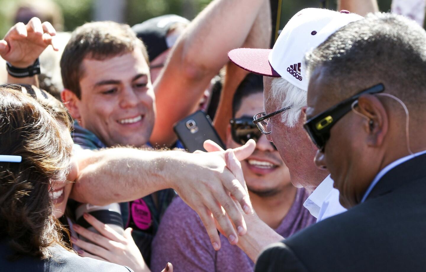 Democratic presidential candidate Bernie Sanders shakes hands with supporters after speaking at Rancho Buena Vista High School in Vista.