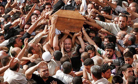 Mourners carry the coffin of Abdul Aziz Hakim in Baghdad during a two-day funeral procession. Thousands poured into the streets of the Iraqi capital Friday to pay their respects to the revered Shiite leader who died of complications from lung cancer.
