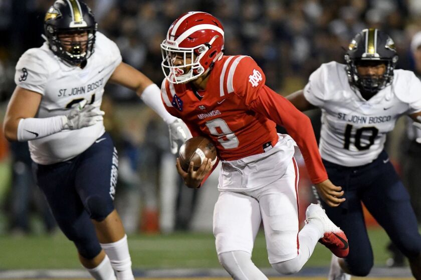 SANTA ANA, CA - OCTOBER 13, 2018: Mater Dei quarterback Bryce Young breaks into the St. John Bosco secondary in the first half, at Santa Ana Stadium. (Michael Owen Baker / For The Times)