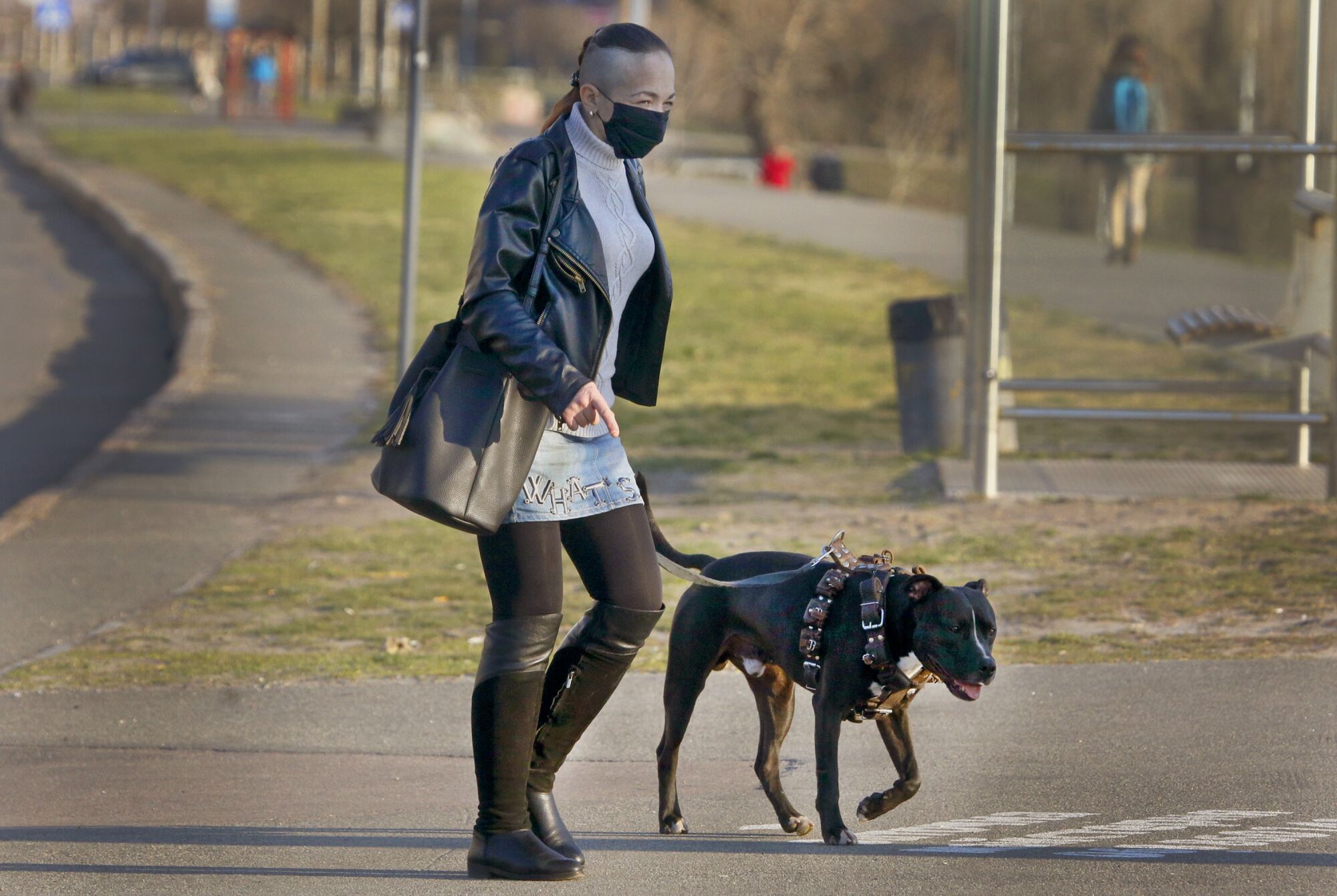 UKRAINE: A woman in a face mask to prevent the coronavirus spread walks a dog in Kyiv, Ukraine, on April 6.