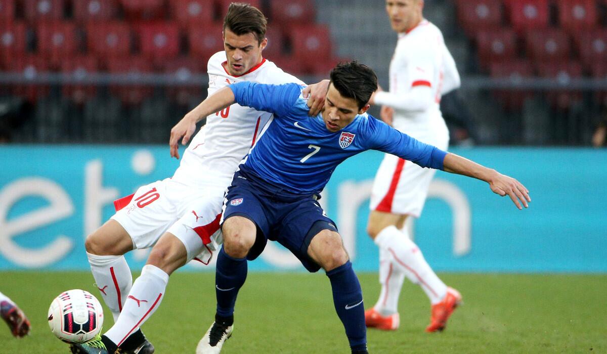 Alfredo Morales (7) of the U.S. fights Switzerland's Granit Xhaka for the ball during an international friendly match Tuesday in Zurich, Switzerland. The teams played to a 1-1 draw.