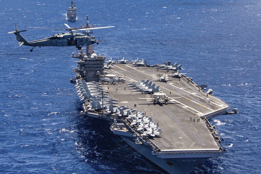 FILE -- In this photo provided by the U.S. Navy, the aircraft carrier USS Carl Vinson participates in a group sail during the Rim of the Pacific exercise off the coast of Hawaii, July 26, 2018. The U.S. military says a Navy F35C Lightning II combat jet conducting exercises in the South China Sea has crashed while trying to land on the deck of the USS Carl Vinson, injuring seven sailors, Monday, Jan. 24, 2022, the military said. (Petty Officer 1st Class Arthurgwain L. Marquez/U.S. Navy via AP, File)
