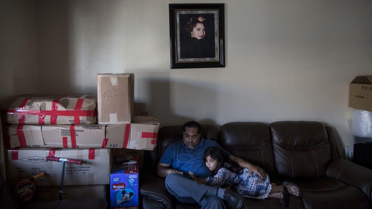 “On the first day of school, I’m not going to have any friends,” Luz. 6, said. Above with father Ricardo Madrigal and daughter amongst moving boxes. (Brian van der Brug / Los Angeles Times)