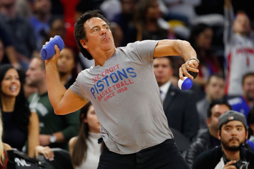 Detroit Pistons owner Tom Gores throws tee shits into the stands during the Detroit Pistons home opener against the Orlando Magic at the Palace of Auburn Hills on October 28, 2016 in Auburn Hills, Michigan.