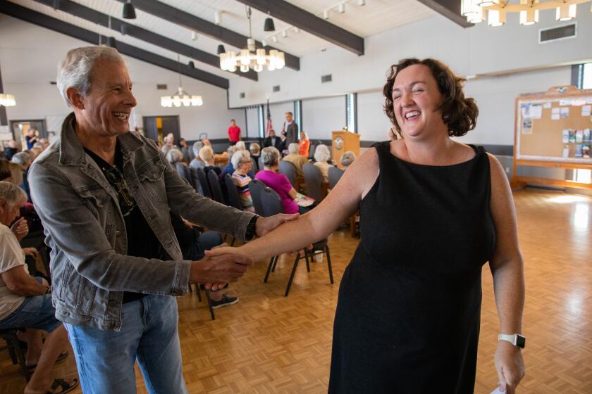 HUNTINGTON BEACH, CA - OCTOBER 17: Richard Bruck of Corona del Mar greets Rep. Katie Porter following her campaign stop at the Huntington Landmark Senior Community in Huntington Beach, CA on Monday, Oct. 17, 2022. Bruck said the two most pressing issues for him were the threat by Republicans to cut Social Security and Medicare. Porter is running for reelection for Congressional District 47 in Orange County. (Myung J. Chun / Los Angeles Times)