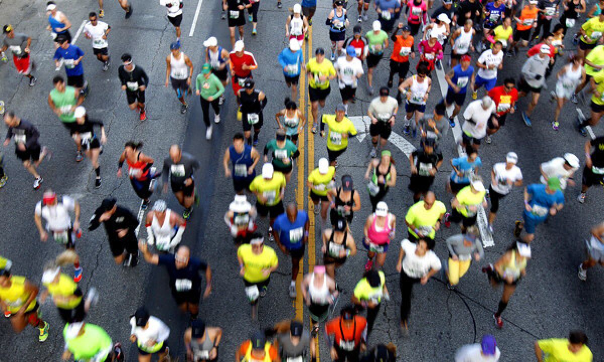 Los Angeles Marathon participants run down Cesar Chavez Avenue in downtown Los Angeles.