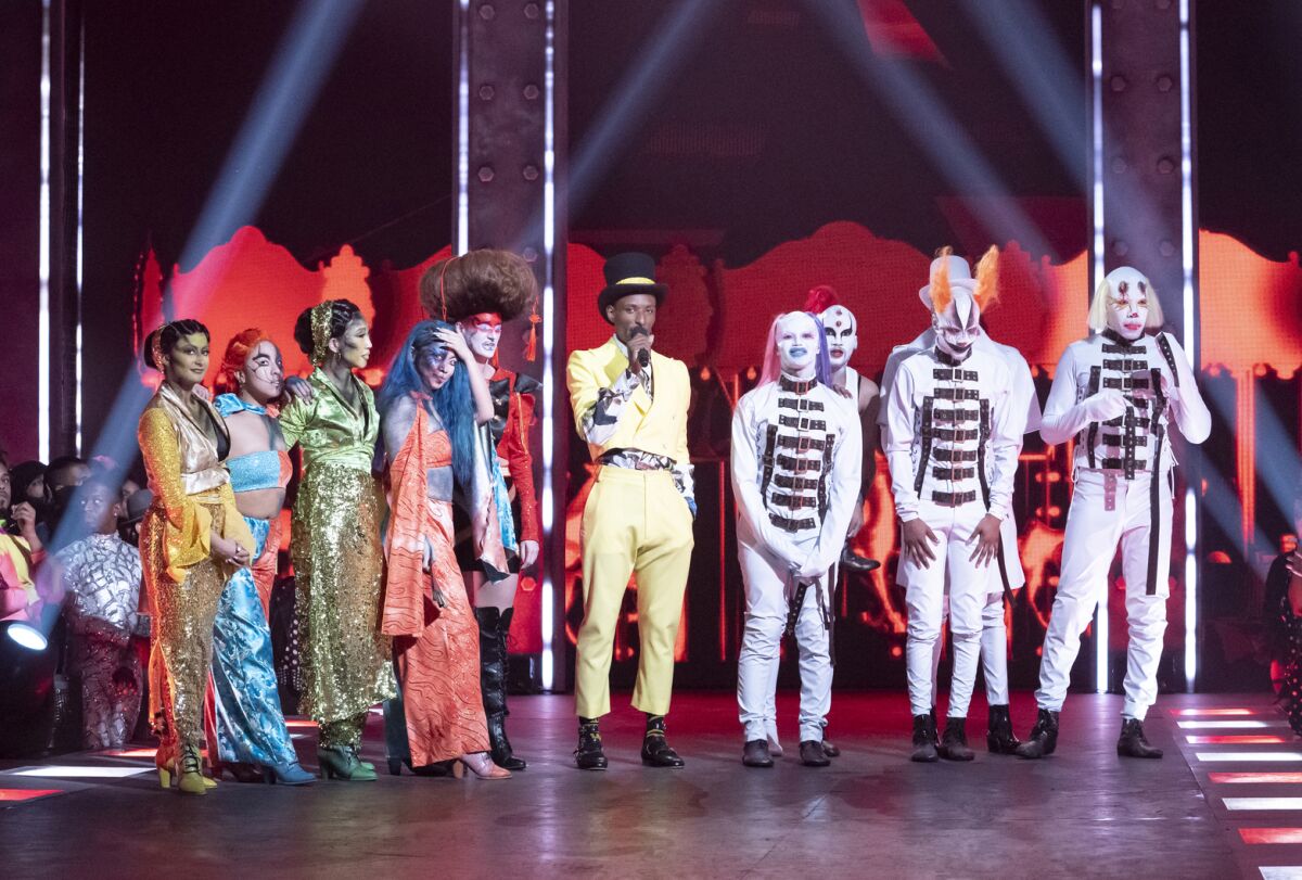 This image released by HBO Max shows Dashaun Wesley, center, with contestants on the series "Legendary." The series lifts the veil off the underground world of ballroom culture, in which historically black and Latino LGBT youths compete in elaborate performances on a runway. (HBO Max via AP)