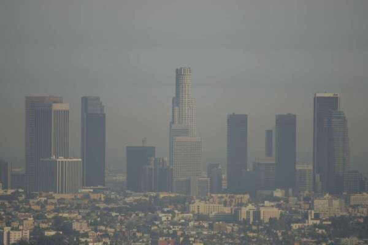 Smoggy days like this one -- Nov. 8, 2005 -- are less frequent today in Los Angeles, even though there are many more cars on the road, according to new research. Scientists credit California's strict emissions standards.