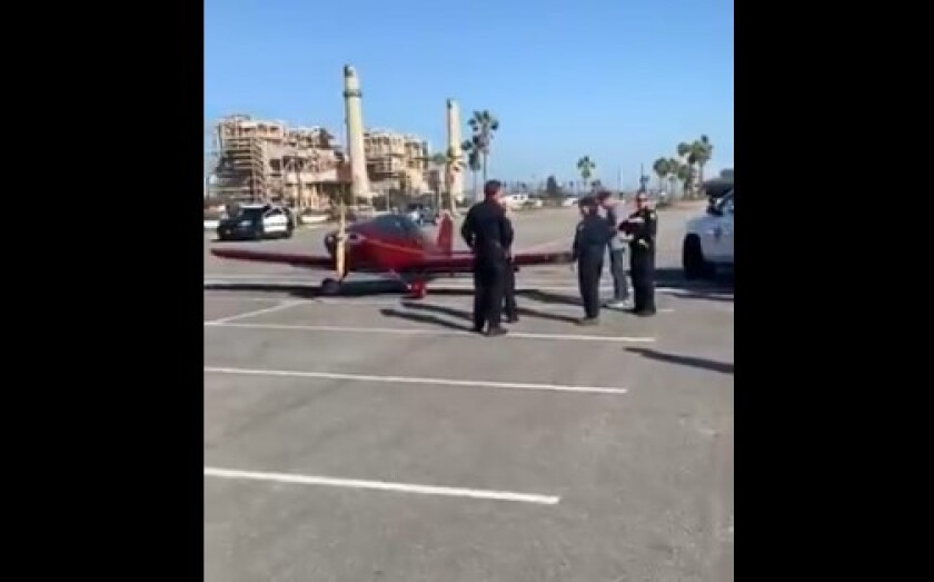 A single-engine Sonex aircraft, seen in an image from video, made an emergency landing on a Huntington State Beach parking lot near Newland Street and Pacific Coast Highway late Monday afternoon. The pilot was not injured.