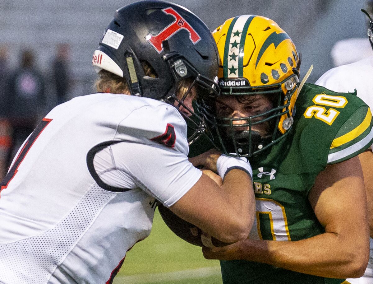 Edison's Peyton Gregory strips the ball from San Clemente quarterback Lachlan Van Rosmalen during a nonleague game Friday.