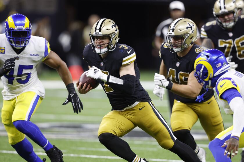 New Orleans Saints' Taysom Hill (7) runs the ball against the Los Angeles Rams in the first half of an NFL football game in New Orleans, Sunday, Nov. 20, 2022. (AP Photo/Butch Dill)