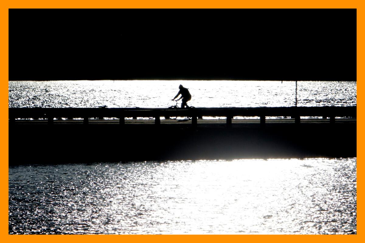 A lone cyclist rides across the bridge on Stanfield Cutoff.