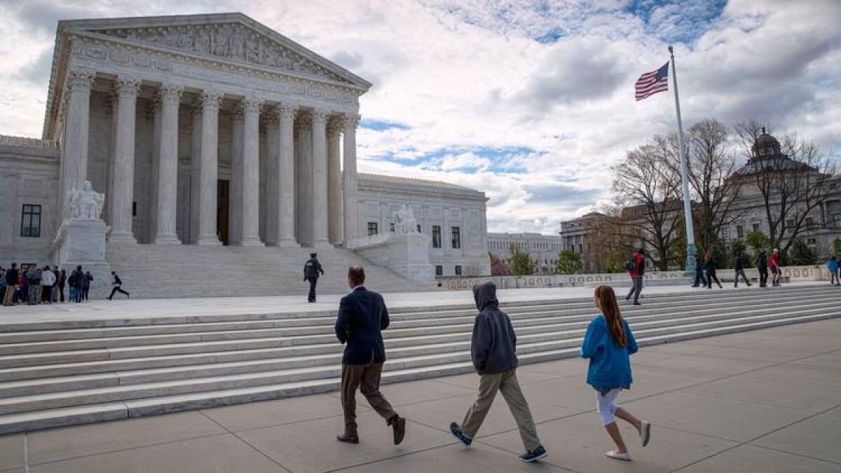 Visitors arrive at the U.S. Supreme Court. The case before the justices involved two defendants in Colorado.