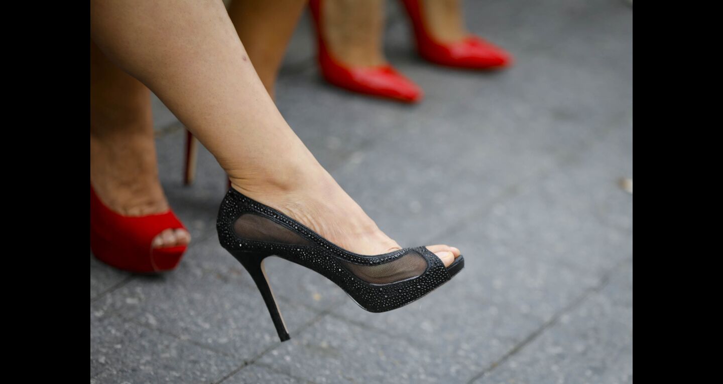 Tee Udompan of North Park, sporting black high heels was one of a couple of hundred people to walk through the Gaslamp Quarter during the YWCA'S 11th annual "Walk a Mile in Her Shoes," taking a stand against domestic violence.