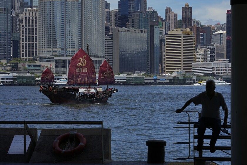 A Chinese junk sails across Victoria Harbor to celebrate the 25th anniversary of Hong Kong handover to China, in Hong Kong, Monday, June 27, 2022. As the former British colony marks the 25th anniversary of its return to China, reeling from pandemic curbs that devastated business and a crackdown on its pro-democracy movement, Hong Kong leaders say it is time to transform again and become a tech center that relies more on ties with nearby Chinese factory cities than on global trade. (AP Photo/Kin Cheung)