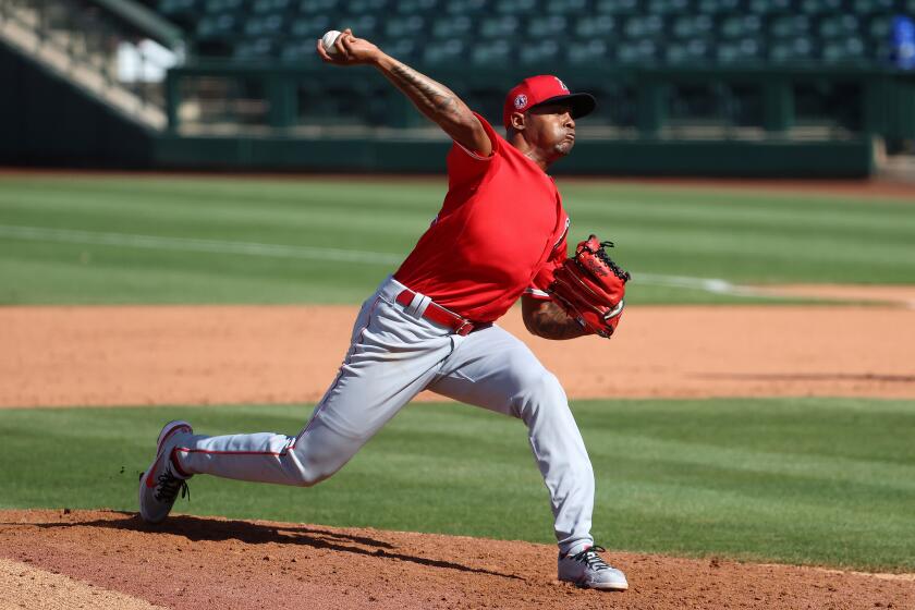 SURPRISE, ARIZONA - MARCH 19: Raisel Iglesias #32 of the Los Angeles Angels pitches in the eighth inning.