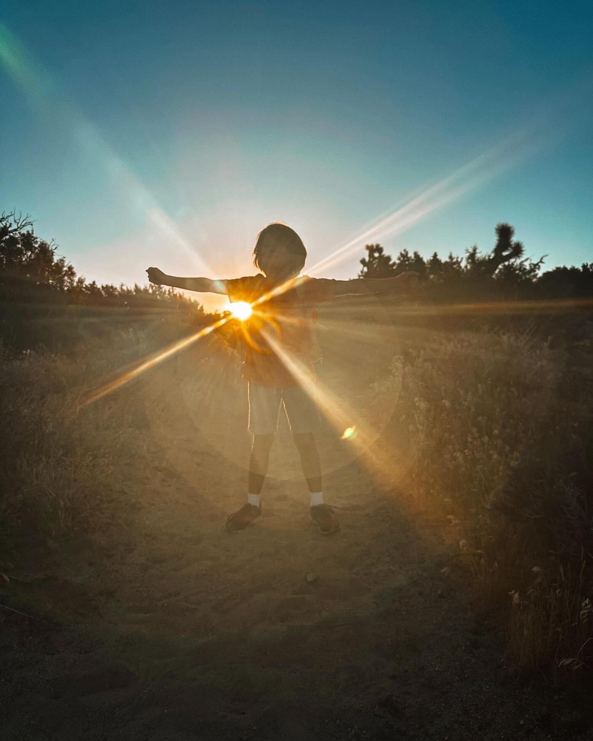 A silhouette of the author's son at sunrise.