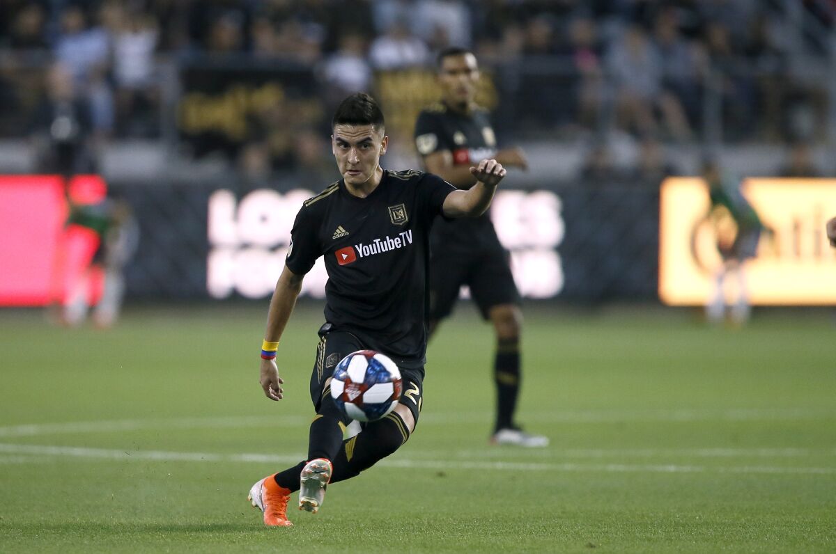Los Angeles FC midfielder Eduard Atuesta (20) passes the ball during the first half of a Major League Soccer game against the Vancouver Whitecaps in Los Angeles, Saturday, July 6, 2019. (AP Photo/Alex Gallardo)