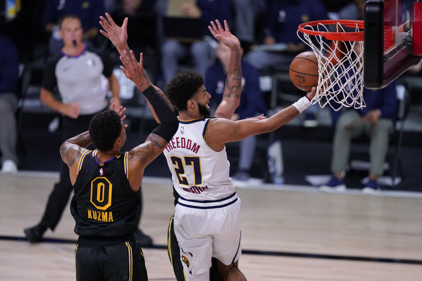 Nuggets guard drives down to the basket against Lakers forward Kyle Kuzma during Game 2.