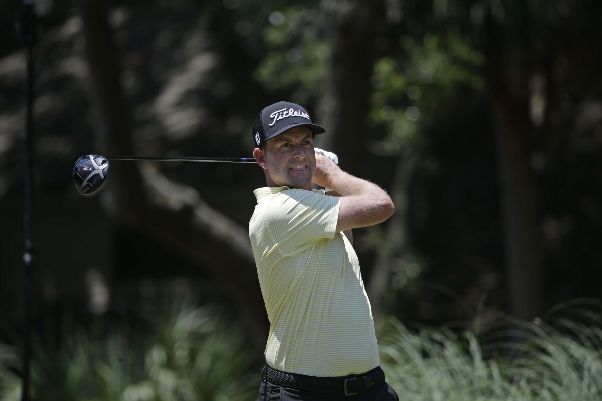 Webb Simpson hits off the second tee during the final round of the RBC Heritage golf tournament.