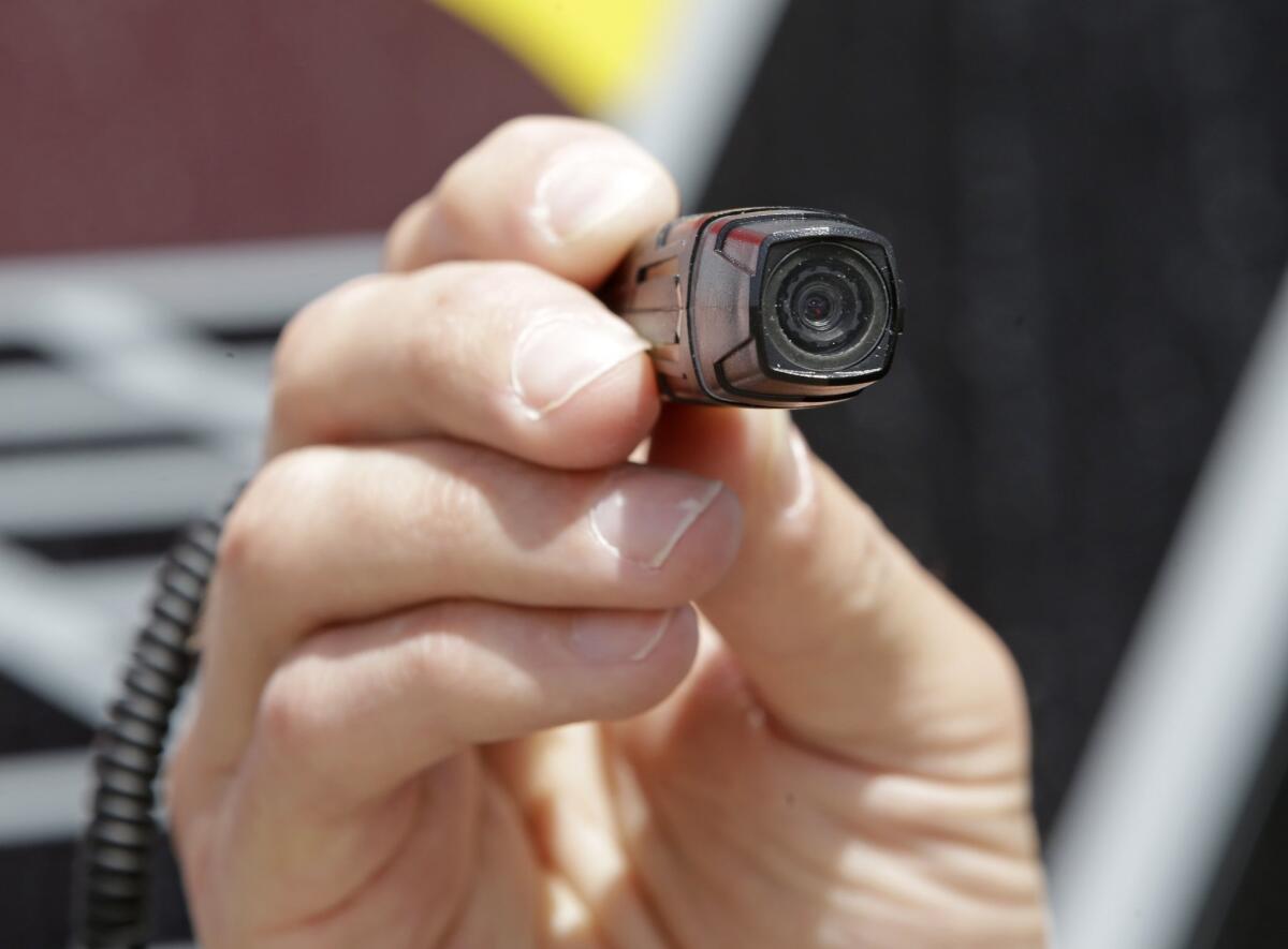 This May 2015 file photo shows Sgt. Mike Fossmo, of the West Valley City Police, demonstrating the use of a body camera, in West Valley City.