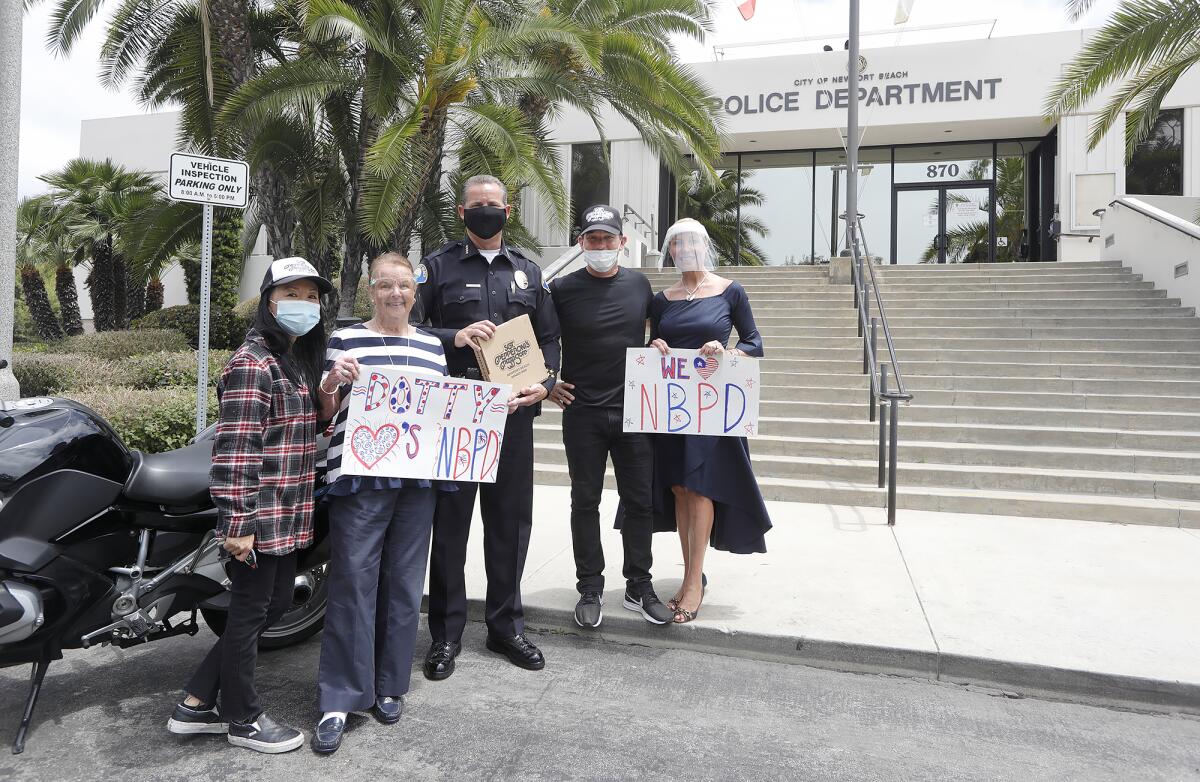 Grace Hong, left, Dotty McDonald, Newport Beach Police Chief Jon Lewis, Jeff Roberts and Julie Ann Ulcickas pose for a photo.