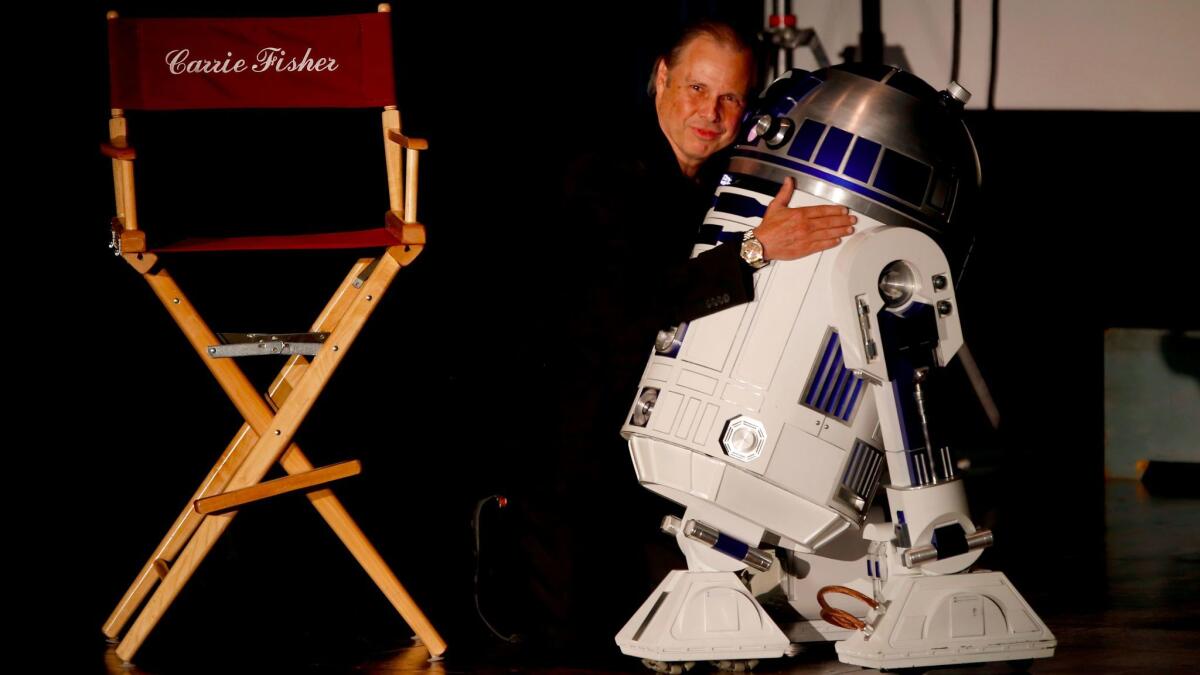 Todd Fisher hugs R2-D2, the beloved droid from "Star Wars." (Francine Orr / Los Angeles Times)
